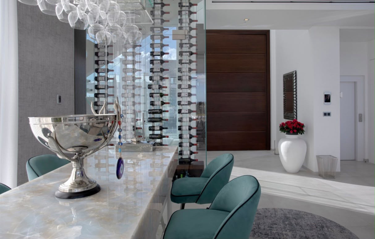 Onyx bar with glass-walled wine cellar behind it