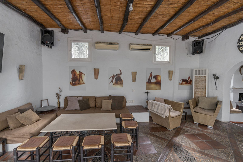 Indoor lounge with white walls and wooden ceiling beams