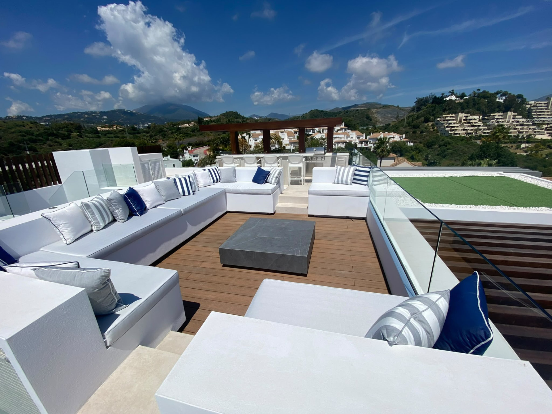 Rooftop terrace with seating, fire table and mountain views