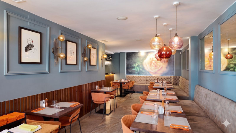 Restaurant interior with laid tables and mural