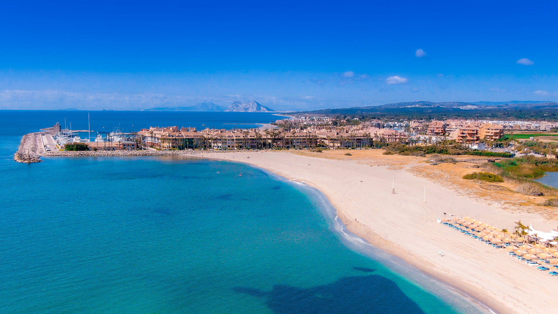 Aerial view of the Sotogrande coastline, beach and marina with the Rock of Gibraltar in the distance