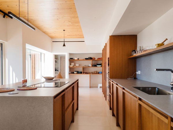 Designer kitchen with central island and walnut cabinetry