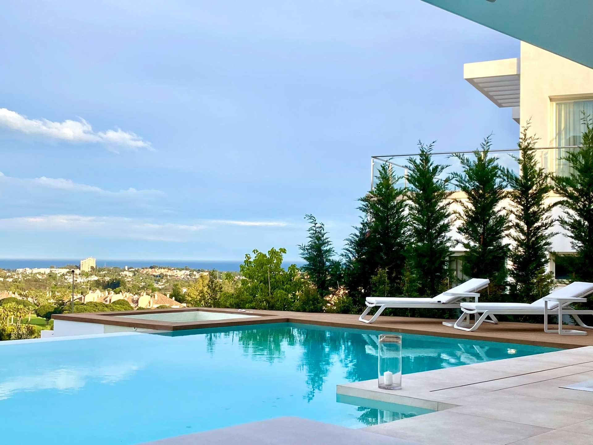 Pool and sun deck with the sea in the distance